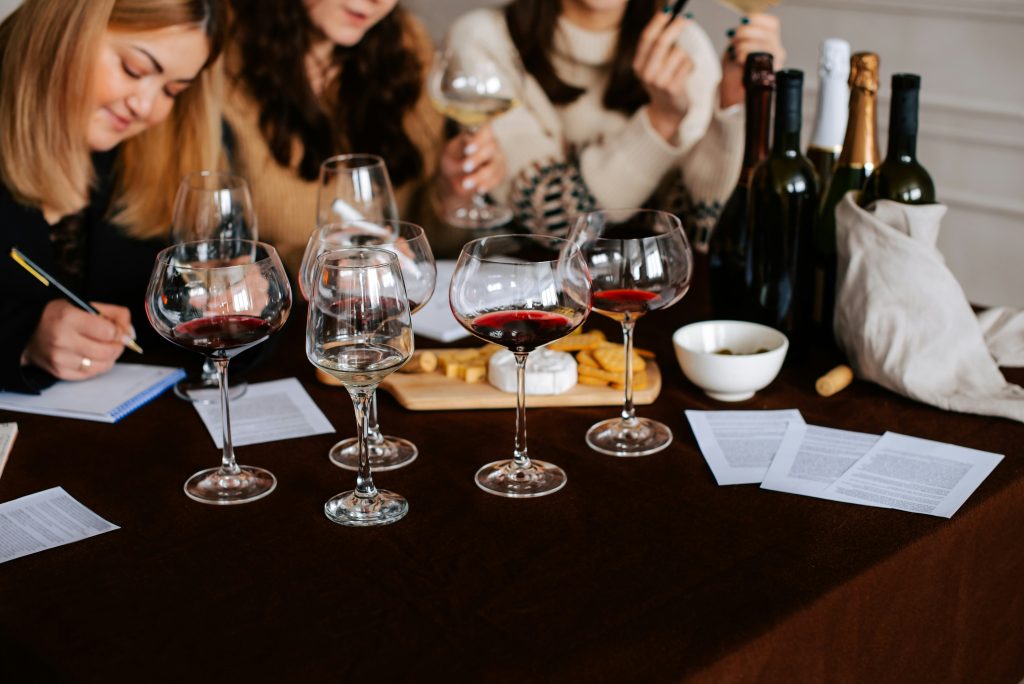 Women enjoying a Paris wine tasting class with a sommelier, sampling French wines in an elegant setting.