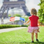 getty-images-Z7jT4DP8WIg-unsplash Small girl in paris spring time Eiffel Tower My Private Paris french flag