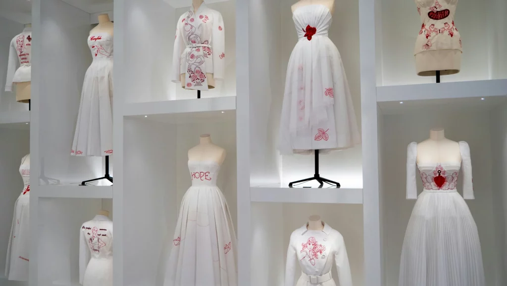 The Dior Gallery in Paris museum with display of Dior's white dresses with red details.My private paris Fashion Tour Paris
