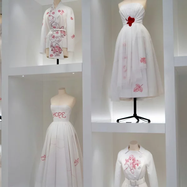 The Dior Gallery in Paris museum with display of Dior's white dresses with red details.My private paris Fashion Tour Paris