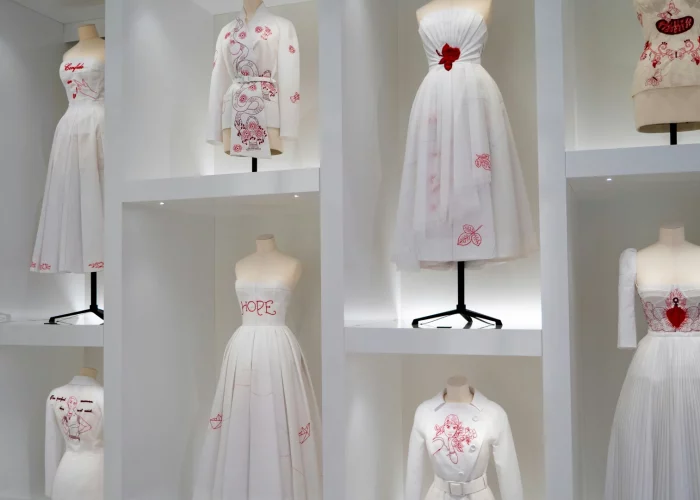 The Dior Gallery in Paris museum with display of Dior's white dresses with red details.My private paris Fashion Tour Paris